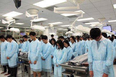Medical students observing a moment of silence in the Respect Ceremony