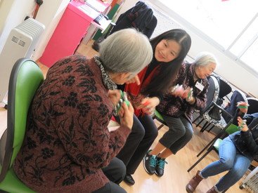 Professor Rainbow Ho engaging the elderly with a musical instrument in the community